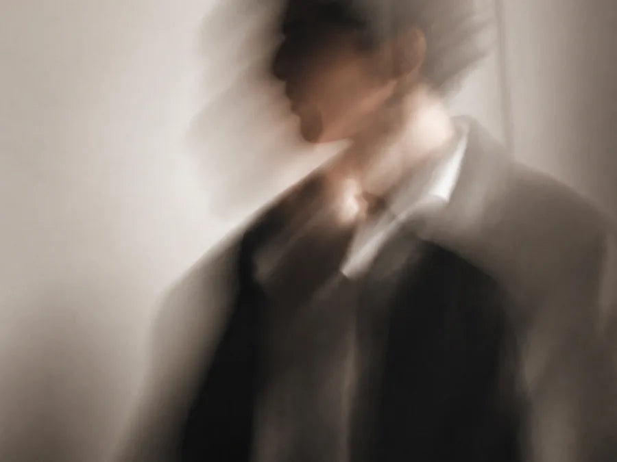 A figure shown in soft, blurred silhouette.